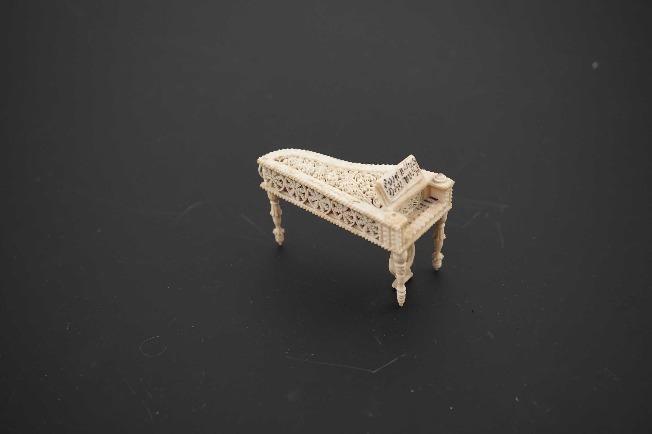 A Napoleonic Prisoner of War bone miniature model of a harpsichord, 6.5cm long. Condition - good